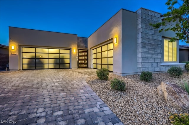 2910 Raywood Ash Dr, Las Vegas, NV 89138 - modern home with stucco siding, decorative driveway, and a garage