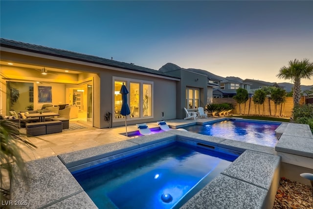 2910 Raywood Ash Dr, Las Vegas, NV 89138 - pool at dusk featuring a fenced in pool, fence, an outdoor hangout area, a patio area, and an in ground hot tub