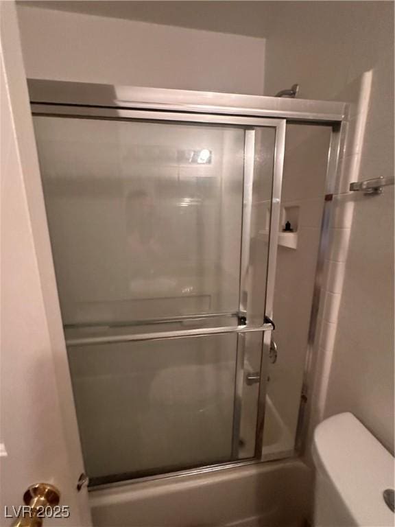 full bathroom featuring enclosed tub / shower combo and toilet