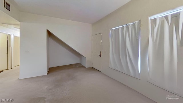 spare room featuring carpet flooring and visible vents