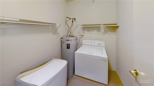 washroom featuring separate washer and dryer, electric water heater, and laundry area