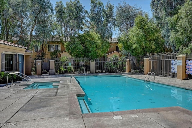 community pool featuring a community hot tub, a patio area, and fence