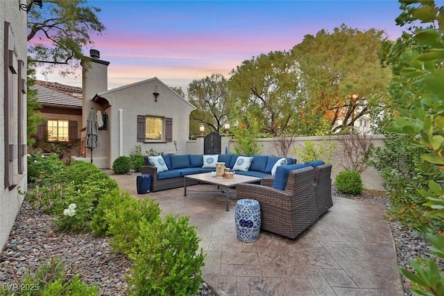 1201 Mersault Ct, Las Vegas, NV 89144 - patio terrace at dusk with a fenced backyard, an outdoor hangout area, a storage unit, and an outdoor structure
