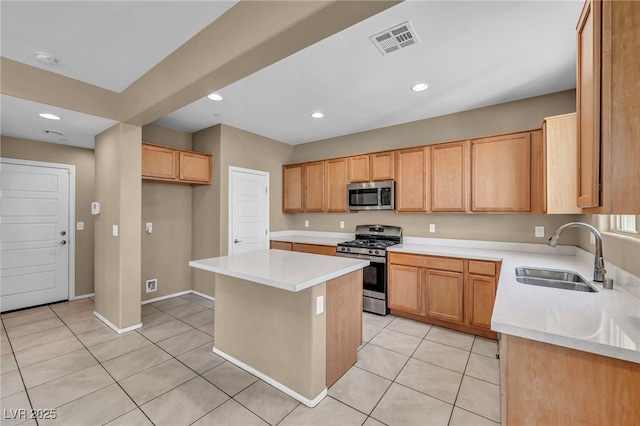 kitchen featuring appliances with stainless steel finishes, a sink, visible vents, and light tile patterned floors