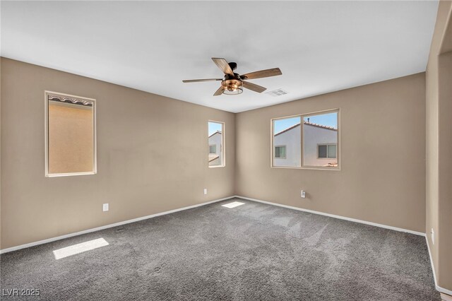 spare room featuring baseboards, a ceiling fan, visible vents, and carpet