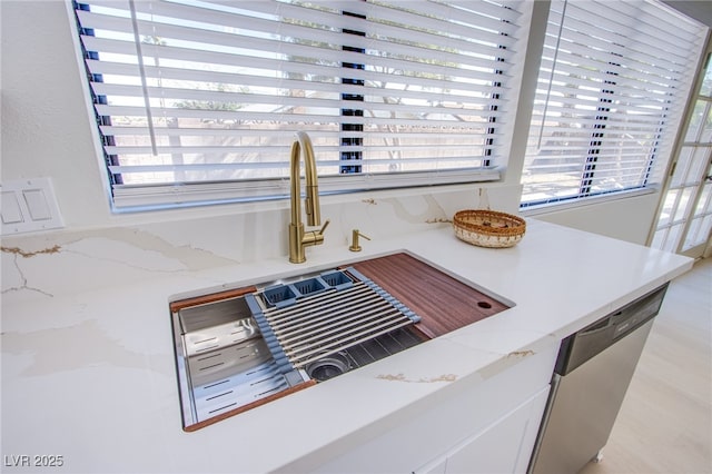3118 Floral Vista Ave, Henderson, NV 89014 - room details featuring light stone counters, stainless steel dishwasher, white cabinetry, and a sink