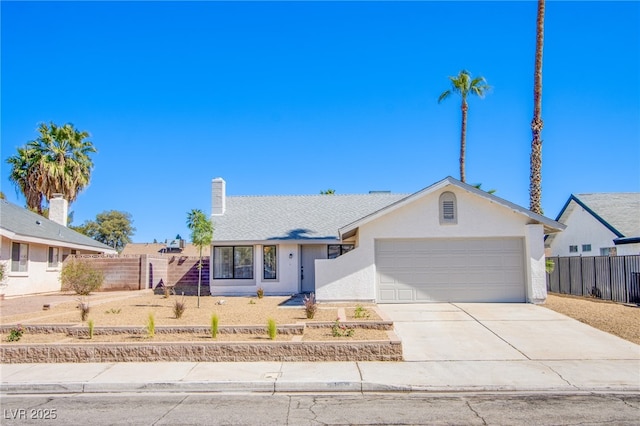 3118 Floral Vista Ave, Henderson, NV 89014 - ranch-style house featuring a chimney, fence, stucco siding, an attached garage, and concrete driveway