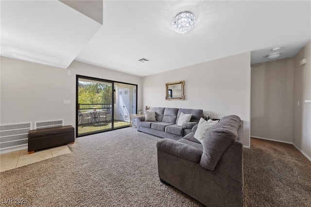 tiled living room with visible vents and carpet