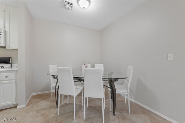 dining area featuring baseboards and visible vents