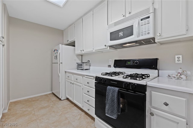 kitchen with white cabinets, light countertops, baseboards, and white appliances