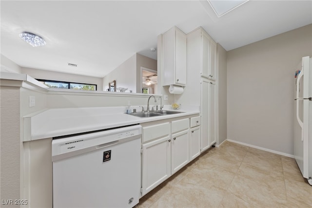 kitchen featuring light countertops, white cabinetry, a sink, white appliances, and ceiling fan
