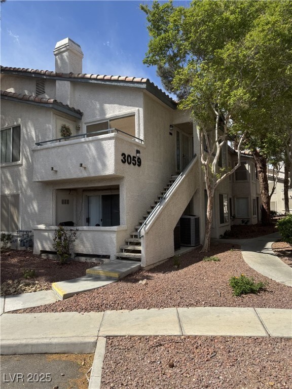 3059 Key Largo Dr Unit 203, Las Vegas, NV 89120 - view of property featuring central AC unit and stairway