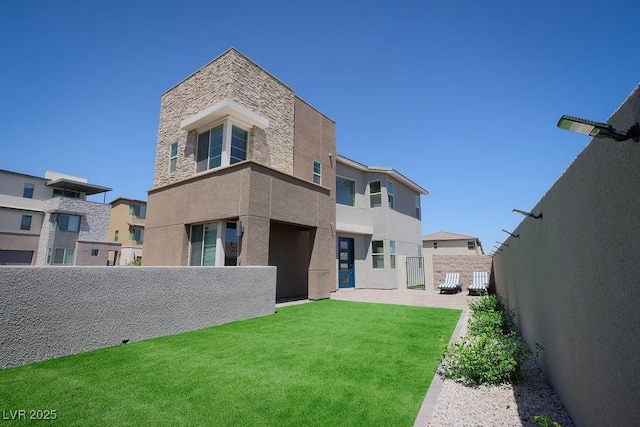6294 Redstone Hills Dr, Las Vegas, NV 89148 - back of house featuring stucco siding, fence, a yard, and stone siding