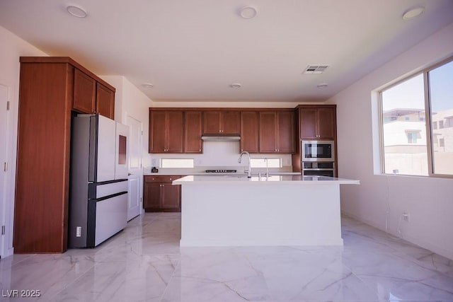 6294 Redstone Hills Dr, Las Vegas, NV 89148 - kitchen featuring a sink, light countertops, stainless steel appliances, under cabinet range hood, and visible vents