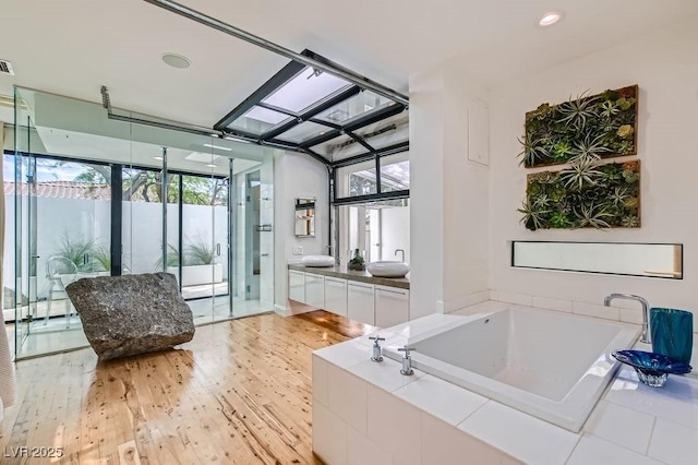 8525 W Verde Way, Las Vegas, NV 89149 - full bath featuring a garden tub, wood finished floors, and vanity