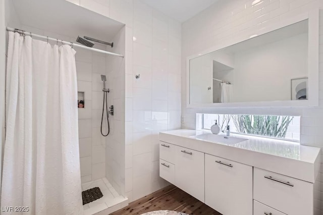 8525 W Verde Way, Las Vegas, NV 89149 - full bath featuring vanity, tiled shower, tile walls, and wood finished floors