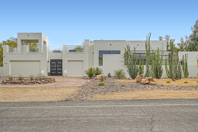8525 W Verde Way, Las Vegas, NV 89149 - view of front of home with stucco siding, an attached garage, driveway, and a balcony