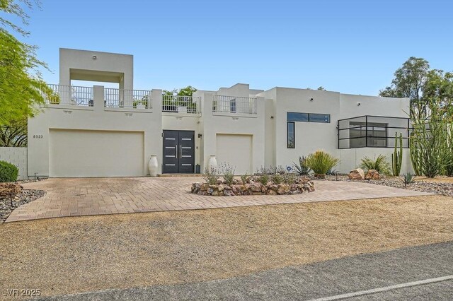8525 W Verde Way, Las Vegas, NV 89149 - view of front of home with stucco siding, an attached garage, and decorative driveway
