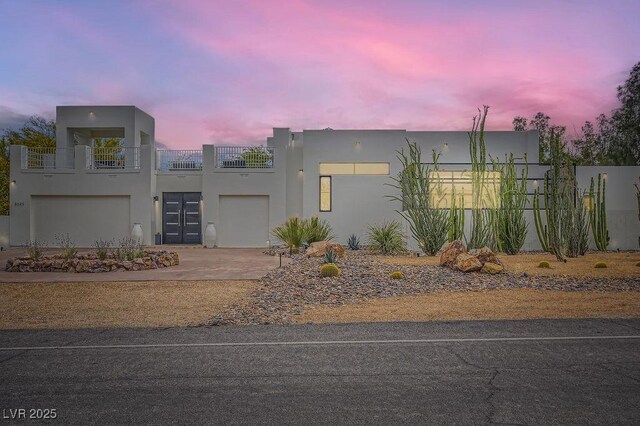 8525 W Verde Way, Las Vegas, NV 89149 - view of front of house featuring stucco siding, a balcony, driveway, and an attached garage