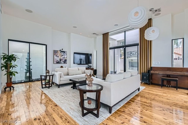 8525 W Verde Way, Las Vegas, NV 89149 - living area with plenty of natural light, wood-type flooring, and a high ceiling