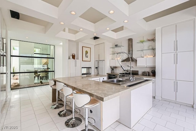 8525 W Verde Way, Las Vegas, NV 89149 - kitchen with wall chimney range hood, coffered ceiling, open shelves, white cabinets, and modern cabinets