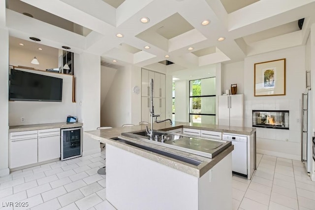 8525 W Verde Way, Las Vegas, NV 89149 - kitchen with wine cooler, an island with sink, coffered ceiling, white cabinetry, and recessed lighting