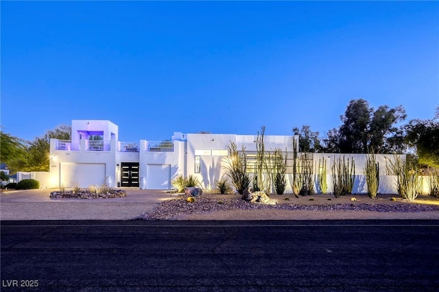 8525 W Verde Way, Las Vegas, NV 89149 - view of front of property with stucco siding, a garage, driveway, and a balcony