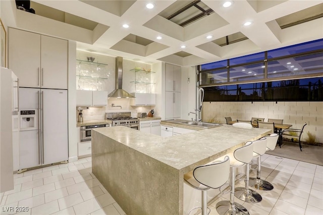 8525 W Verde Way, Las Vegas, NV 89149 - kitchen with high quality appliances, wall chimney range hood, coffered ceiling, decorative backsplash, and recessed lighting