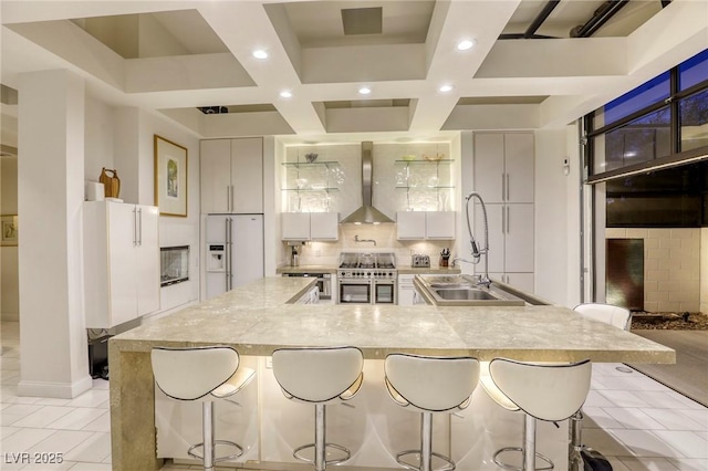 8525 W Verde Way, Las Vegas, NV 89149 - kitchen featuring wall chimney range hood, white fridge with ice dispenser, double oven range, recessed lighting, and coffered ceiling