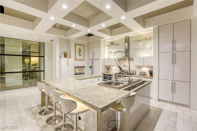 8525 W Verde Way, Las Vegas, NV 89149 - kitchen with modern cabinets, coffered ceiling, a spacious island, recessed lighting, and a kitchen bar