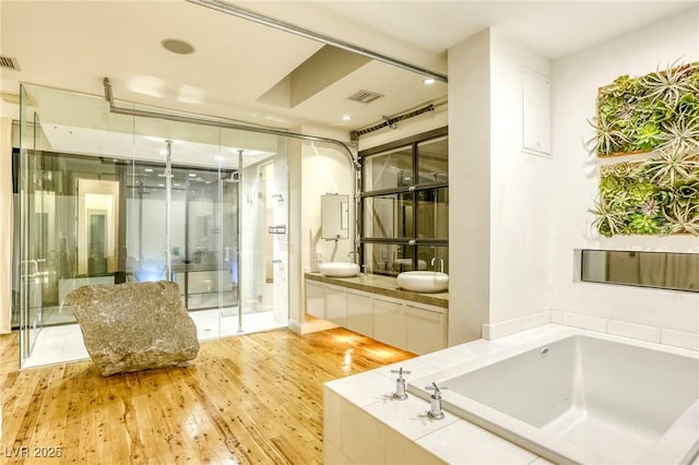 8525 W Verde Way, Las Vegas, NV 89149 - full bath with a bath, vanity, wood finished floors, and a stall shower