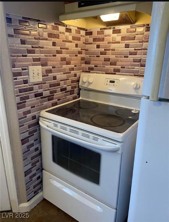 1385 Ringe Ln, Las Vegas, NV 89110 - kitchen featuring white appliances, under cabinet range hood, tile walls, and tasteful backsplash