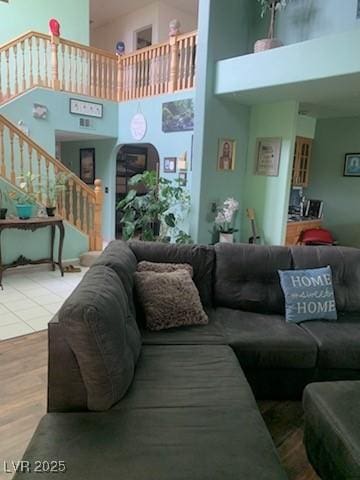 1385 Ringe Ln, Las Vegas, NV 89110 - living area with a towering ceiling, stairway, wood finished floors, and arched walkways