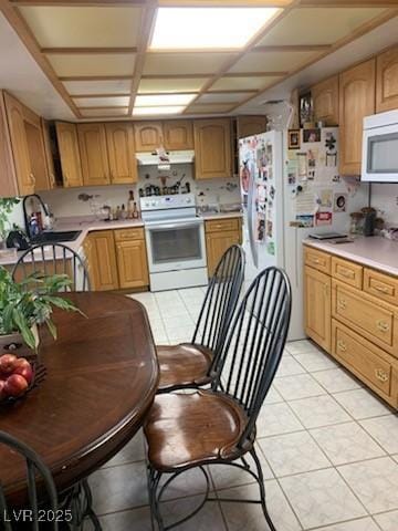 1385 Ringe Ln, Las Vegas, NV 89110 - kitchen with white appliances, under cabinet range hood, a sink, and light countertops