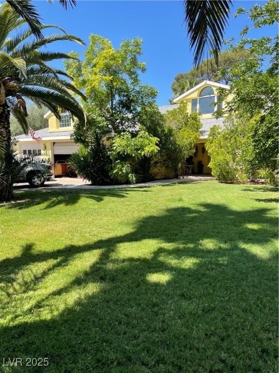 1385 Ringe Ln, Las Vegas, NV 89110 - view of grassy yard with a garage