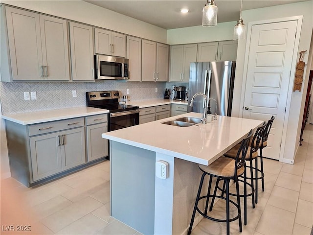 4286 E Cactus Canyon Dr, Pahrump, NV 89061 - kitchen featuring gray cabinets, light tile patterned flooring, stainless steel appliances, and a sink