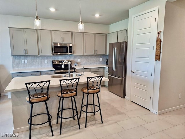 4286 E Cactus Canyon Dr, Pahrump, NV 89061 - kitchen with a sink, decorative backsplash, gray cabinets, stainless steel appliances, and light countertops