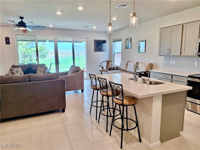 4286 E Cactus Canyon Dr, Pahrump, NV 89061 - kitchen featuring open floor plan, visible vents, appliances with stainless steel finishes, gray cabinets, and a breakfast bar area