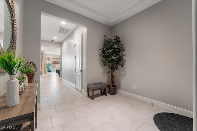 corridor featuring light tile patterned flooring, visible vents, baseboards, and recessed lighting