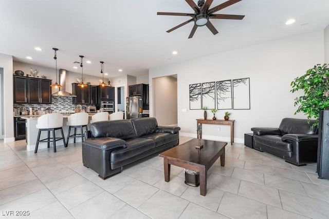 living room with recessed lighting, baseboards, ceiling fan, and light tile patterned floors