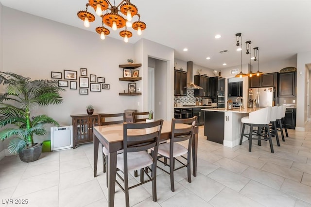 dining space with visible vents, recessed lighting, a chandelier, and light tile patterned flooring