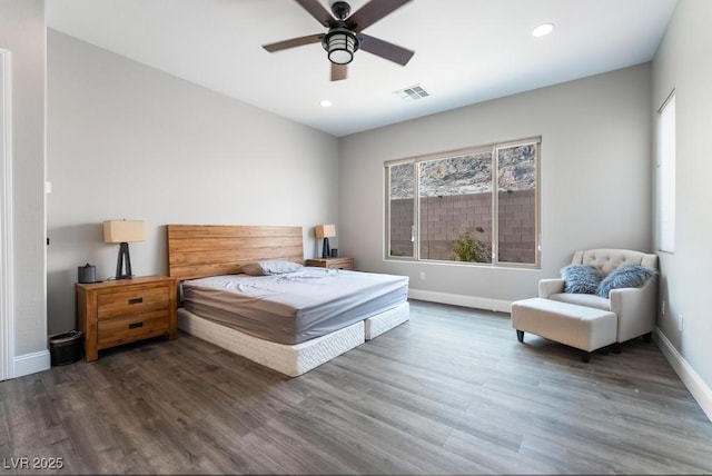 bedroom featuring visible vents, baseboards, wood finished floors, and recessed lighting