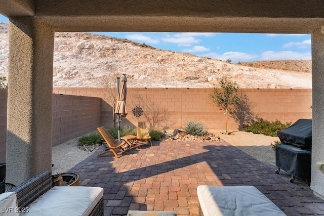 view of patio with a fenced backyard and a mountain view