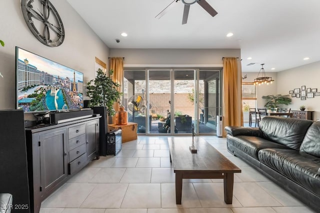 living area with light tile patterned floors, recessed lighting, french doors, and ceiling fan with notable chandelier