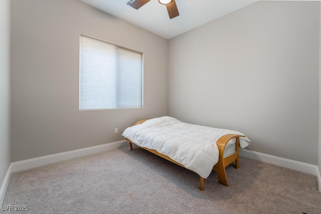 carpeted bedroom featuring a ceiling fan and baseboards