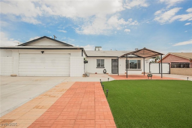 ranch-style home with driveway, fence, a garage, and a front yard