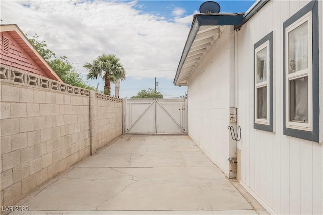 view of patio with a gate and fence
