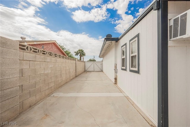 view of side of home featuring a gate and fence