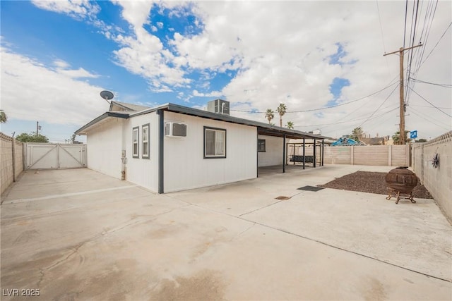 rear view of house with a gate, central air condition unit, a patio, and a fenced backyard