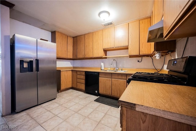 kitchen with black appliances, a sink, visible vents, and light countertops